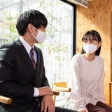 日本製・オーガニックコットン生地の布マスクを付けて話す人